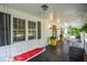 Relaxing front porch with a swing and comfortable seating arrangements at 5500 Georgetown Sw Trce, Lilburn, GA 30047