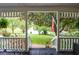View from the charming front porch, showcasing a well-manicured lawn at 5500 Georgetown Sw Trce, Lilburn, GA 30047