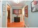Hallway featuring beautiful hardwood floors, elegant artwork, and decorative lighting offering seamless transition between rooms at 5500 Georgetown Sw Trce, Lilburn, GA 30047