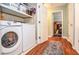Convenient laundry room features modern washer and dryer, plus extra storage at 5500 Georgetown Sw Trce, Lilburn, GA 30047
