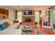 Bright living room with a brick fireplace, large windows, neutral colored sofa, and hardwood floors at 5500 Georgetown Sw Trce, Lilburn, GA 30047