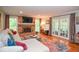 Spacious living room with brick fireplace, large windows, and view to the outdoor screened porch at 5500 Georgetown Sw Trce, Lilburn, GA 30047