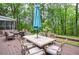 Outdoor dining area with a table, umbrella, and seating for six on a wooden deck at 5500 Georgetown Sw Trce, Lilburn, GA 30047