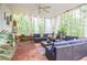 Large screened porch with comfortable furniture and a serene view of the surrounding nature at 5500 Georgetown Sw Trce, Lilburn, GA 30047
