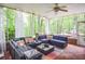 Bright screened porch with comfortable seating and a peaceful view of surrounding trees at 5500 Georgetown Sw Trce, Lilburn, GA 30047