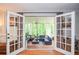 View from home to the screened-in porch, showing seating area and natural light at 5500 Georgetown Sw Trce, Lilburn, GA 30047