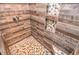 Modern shower featuring eye-catching tiled walls and floor with inset mosaic shelves and a rainfall shower head at 5500 Georgetown Sw Trce, Lilburn, GA 30047