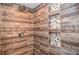 Modern shower featuring eye-catching tiled walls with inset mosaic shelves and a rainfall shower head at 5500 Georgetown Sw Trce, Lilburn, GA 30047