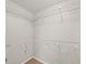 Walk-in closet with built-in shelving and ample storage space at 303 Mill Pond Se Ct, Smyrna, GA 30082