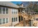 Inviting exterior view showcasing a two-story home with wooden decks and lots of windows for natural light at 303 Mill Pond Se Ct, Smyrna, GA 30082
