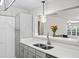 Bright kitchen features stainless steel sink, white countertops, gray cabinets, and stylish pendant lighting at 303 Mill Pond Se Ct, Smyrna, GA 30082