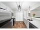 Updated kitchen featuring stainless steel appliances, tile floors, and white cabinets and countertops at 303 Mill Pond Se Ct, Smyrna, GA 30082