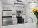 Updated kitchen featuring stainless appliances and bright white quartz countertops and gray cabinets at 303 Mill Pond Se Ct, Smyrna, GA 30082