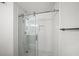 Modern tiled shower with glass door and chrome fixtures at 303 Mill Pond Se Ct, Smyrna, GA 30082