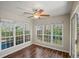Sunroom boasts abundant natural light, ceiling fan, and wood-look flooring at 303 Mill Pond Se Ct, Smyrna, GA 30082