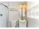Bathroom with glass shower, white vanity with sink, and a large oval mirror at 3588 Swallow Ln, Decatur, GA 30032