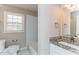 Bright bathroom featuring a white vanity with granite countertop, and a white tiled shower/tub at 3588 Swallow Ln, Decatur, GA 30032