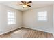Bedroom with neutral carpeting, ceiling fan with lighting, and two windows bringing in natural light at 3588 Swallow Ln, Decatur, GA 30032