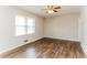 Cozy bedroom with natural light, laminate floors, a ceiling fan, and neutral paint at 3588 Swallow Ln, Decatur, GA 30032