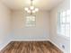 Bright dining area with modern laminate floors, a window, and a stylish chandelier at 3588 Swallow Ln, Decatur, GA 30032