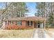 Cozy brick home featuring a covered carport and a well-maintained front yard surrounded by mature trees at 3588 Swallow Ln, Decatur, GA 30032