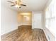 Bright living room featuring modern laminate floors, a ceiling fan, and lots of natural light at 3588 Swallow Ln, Decatur, GA 30032