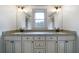Bathroom vanity featuring double sinks, granite countertops, and custom cabinetry at 111 Carter Ln, Canton, GA 30115
