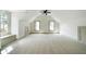 Spacious carpeted bonus room with neutral tones, natural light, and a ceiling fan at 111 Carter Ln, Canton, GA 30115