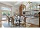 Dining room with table, chairs, and view of living area with fireplace and large arched windows at 111 Carter Ln, Canton, GA 30115