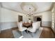 Beautiful dining room with detailed ceiling, hardwood floors, wainscoting, and modern light fixture at 111 Carter Ln, Canton, GA 30115