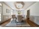 Dining room featuring decorative tray ceiling, hardwood floors, wainscoting, and seating for eight at 111 Carter Ln, Canton, GA 30115