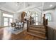 Open-concept dining room adjacent to living area with high ceilings and hardwood floors at 111 Carter Ln, Canton, GA 30115