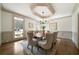 Elegant dining room with a tray ceiling, hardwood floors, wainscoting, and seating for eight at 111 Carter Ln, Canton, GA 30115