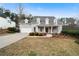 Charming two-story home featuring a landscaped front yard, attached two car garage and covered front porch at 111 Carter Ln, Canton, GA 30115