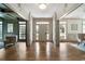 Elegant foyer featuring hardwood floors, detailed molding, and a front door with sidelights for natural light at 111 Carter Ln, Canton, GA 30115