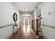 Inviting hallway with hardwood floors, staircase, decorative mirror, and view to the front door at 111 Carter Ln, Canton, GA 30115