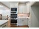 Built-in stainless steel microwave and oven in kitchen with custom cabinets and stone countertops at 111 Carter Ln, Canton, GA 30115