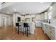 Open kitchen with white cabinetry, breakfast bar, hardwood floors, and modern appliances at 111 Carter Ln, Canton, GA 30115