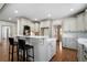Spacious kitchen featuring gray cabinets, white countertops, and a breakfast bar with seating at 111 Carter Ln, Canton, GA 30115