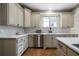Well-lit kitchen featuring shaker cabinets, stainless steel appliances, and a stylish marble backsplash at 111 Carter Ln, Canton, GA 30115