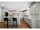 Large kitchen showcasing an island with seating, stone countertops, and stainless steel appliances at 111 Carter Ln, Canton, GA 30115