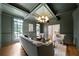 Sophisticated living room with coffered ceiling, hardwood floors, large windows, and modern decor at 111 Carter Ln, Canton, GA 30115