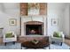 Living room with brick fireplace, mantel, and comfortable seating area at 111 Carter Ln, Canton, GA 30115