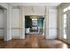 Open living room with hardwood floors, decorative molding, and a view into another living space at 111 Carter Ln, Canton, GA 30115