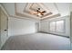 Large main bedroom with neutral carpet, tray ceiling and ensuite bathroom at 111 Carter Ln, Canton, GA 30115