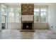 Sunroom with fireplace and multiple windows showcasing a backyard view at 111 Carter Ln, Canton, GA 30115