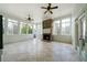 Bright sunroom with stone fireplace, tile flooring, and multiple windows at 111 Carter Ln, Canton, GA 30115