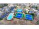 Aerial view of tennis courts and a pool with a paved parking lot nearby in the neighborhood at 1915 Turtle Creek Way, Lawrenceville, GA 30043