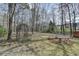 Large, unfenced backyard with mature trees and a lush, grassy lawn at 1915 Turtle Creek Way, Lawrenceville, GA 30043