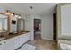 Bright, spacious bathroom featuring double sinks and framed mirrors, and tiled floors at 1915 Turtle Creek Way, Lawrenceville, GA 30043